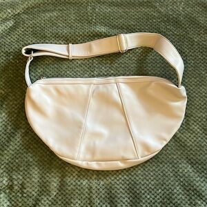 Cream colored handbag. New, never used. Inside zip pocket.